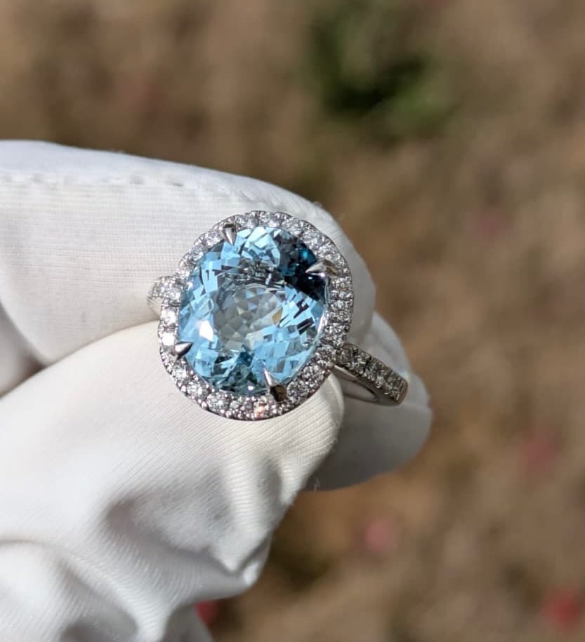Aquamarine and diamond halo ring in white gold